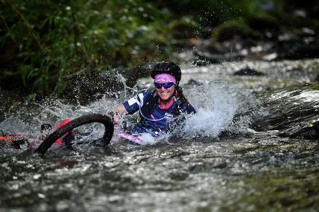 A woman competes in the mountain bike race as part of the “Raid des Alizes”, an exclusively all-female multi sport competition on the French Caribbean island of Martinique on November 28, 2019. Teams compete along trails which are kept undisclosed until the day, is different disciplines such as Mountain biking, running, and canoing. Each team also has to select and represent a charity project during the competition. According to the final ranking, donations will be directly processed in favour of the represented associations. (Photo by Anne-Christine Poujoulat/AFP Photo)