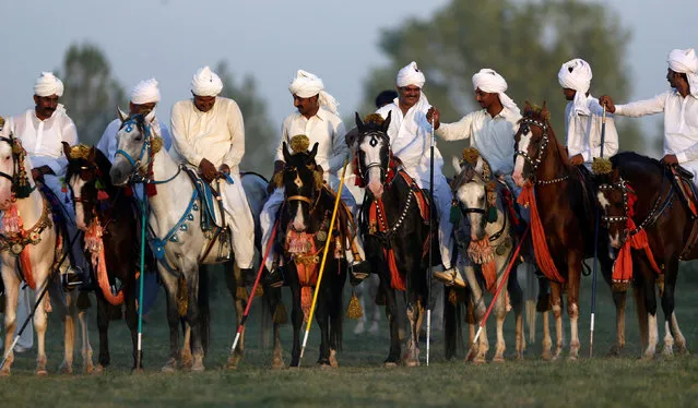 Riders chat between rounds at the Margalla Festival Tent Pegging Championship in Islamabad, Pakistan June 5, 2016. (Photo by Caren Firouz/Reuters)