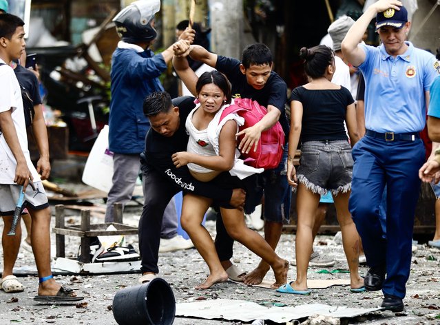 Filipino informal settlers run for safety during a demolition raid at a shanty town in Pasay City, Metro Manila, Philippines, 01 August 2024. (Photo by Francis R. Malasig/EPA)