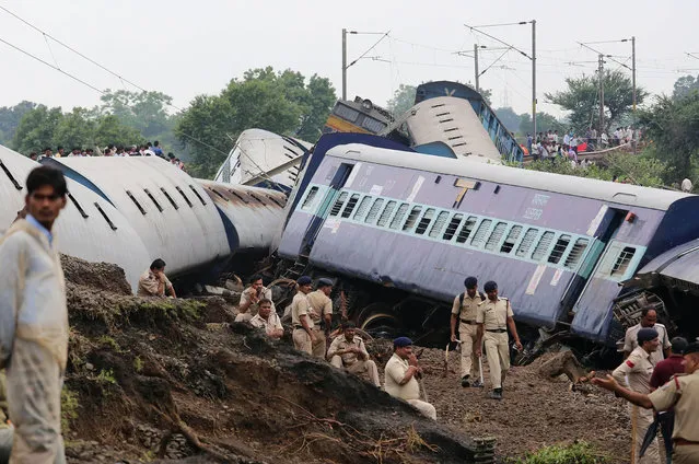 Indian policemen take a rest after rescue works at the site of a train accident at 180 kilometers from Bhopal near Harda district of Mahdya Pradesh, India 05 August 2015. (Photo by Sanjeev Gupta/EPA)