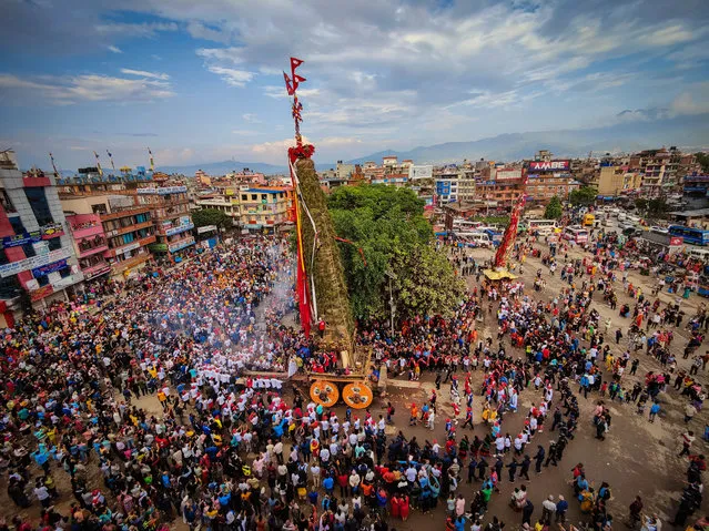 Devotees pull the chariots of Rato Machhendranath and Minnath during the Rato Machhendranath Chariot festival at Lagankhel, Lalitpur, Nepal on May 11, 2022. Rato Machhendranath is worshipped as god of rain by both Hindus and Buddhists and the chariot festival is one of the longest festival of Nepal. (Photo by Sunil Sharma/ZUMA Press Wire/Eyevine)