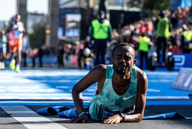 Ethiopia's Milkesa Mengesha reacts on the ground after winning the 50th edition of the Berlin Marathon in Berlin, Germany on September 29, 2024. (Photo by John MacDougall/AFP Photo)