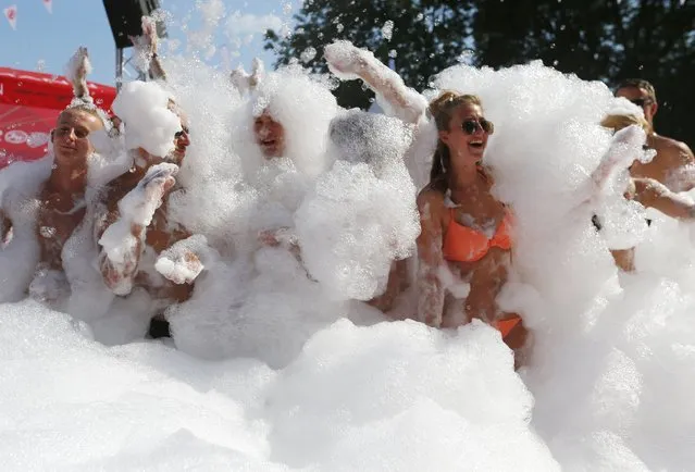 Revellers play with foam during the Sziget music festival on an island in the Danube River in  Budapest, Hungary August 12, 2015. (Photo by Laszlo Balogh/Reuters)