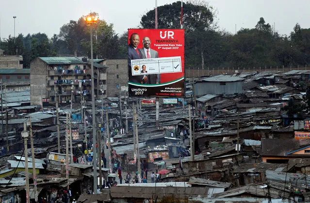 An election campaign billboard displaying Kenya's President Uhuru Kenyatta and Deputy President William Ruto is pictured in Mathare slum in Nairobi, Kenya August 10, 2017. (Photo by Thomas Mukoya/Reuters)