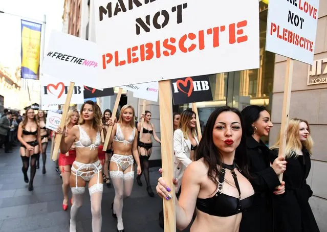Models in lingerie are seen walking the streets of Sydney during a marketing campaign in support of marriage equality in Sydney, Australia on August 14, 2017. On Monday, 60 Honey Birdette employees took to the streets of the Sydney CBD in support for marriage equality ahead of the federal government’s controversial postal plebiscite on the topic, with forms slated to arrive in Australians’ mailboxes on September 12. (Photo by PA Wire)