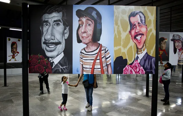 People visit an exhibition of cartoon caricature art of characters made famous by Roberto Gomez Bolanos, the late Mexican writer and comedian who wrote and played the boy television character El Chavo that defined a generation for millions of Latin American children, in Mexico City, Thursday, August 17, 2017. Gomez, known as “Chespirito” (chess-pee-REE-to), or Little Shakespeare, changed comedy in Latin America, taking his inspiration from Laurel and Hardy as well as Cantinflas, Mexico's other transcendent comedian who eventually made it to Hollywood. (Photo by Eduardo Verdugo/AP Photo)