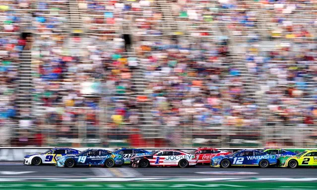 NASCAR Cup Series driver Chase Elliott (9) and NASCAR Cup Series driver Martin Truex Jr. (19) lead the pack to a restart during the Quaker State 400 at Atlanta Motor Speedway in Hampton, Georgia on July 10, 2022. (Photo by John David Mercer/USA TODAY Sports)