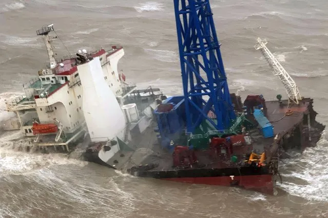 This handout photo taken and released by the Hong Kong Government Flying Service on July 2, 2022 shows a ship after it broke into two amid Typhoon Chaba, during a rescue operation of the crew members in the South China Sea 160 nautical miles southwest of Hong Kong. More than two dozen crew members are unaccounted for after their ship broke into two during a typhoon in the South China Sea on July 2, with rescuers scrambling to find them, officials say. (Photo by Handout/Government Flying Service/AFP Photo)