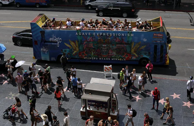 Tourists travel down Hollywood boulevard on a tour bus as they visit Hollywood, California, U.S. August 3, 2017. (Photo by Mike Blake/Reuters)