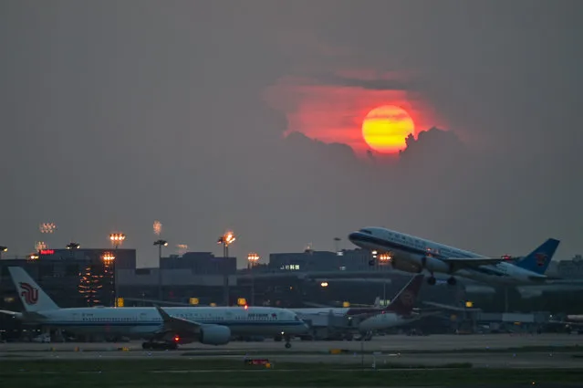 A general view of Hongqiao International Airport during the sunset, in Shanghai, on August 2, 2022. (Photo by Hector Retamal/AFP Photo)