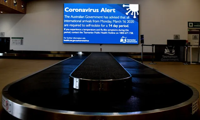 Signage giving travellers updates on coming restrictions at Hobart airport on March 19, 2020 in Hobart, Australia. The Tasmanian premier Peter Gutwein has announced all interstate travellers will be required to quarantine for 14 days. The measures are the toughest to be imposed in Australia, and will come into effect from Friday 20 March. There are now 596 confirmed cases of COVID-19 In Australia, while there have been six confirmed deaths, five in NSW and one in Western Australia. (Photo by Steve Bell/Getty Images)