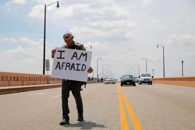 A man crosses the Hope Memorial Bridge behind an anti-Trump protest to coincide with the Republican National Convention in Cleveland, Ohio, U.S., July 21, 2016. (Photo by Andrew Kelly/Reuters)