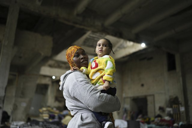 Sierra Leonean migrant worker Isatta Bah, 24, smiles as she holds her daughter, Blessing, one year old, during an interview with The Associated Press while waiting to be repatriated back home, as they are sheltered at a former car dealership in Hazmieh, east of Beirut, Lebanon, Wednesday, December 4, 2024. (Photo by Hassan Ammar/AP Photo)