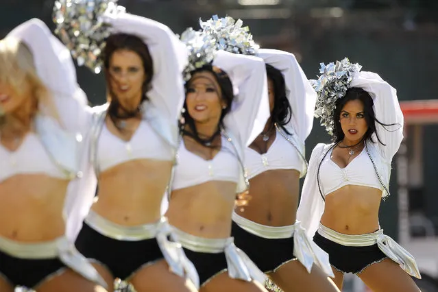 September 29, 2013; Oakland, CA, USA; Cheerleaders from the Oakland Raiders raiderettes squad perform during a break in the action against the Washington Redskins in the third quarter at O.co Coliseum. (Photo by Cary Edmondson/USA TODAY Sports)