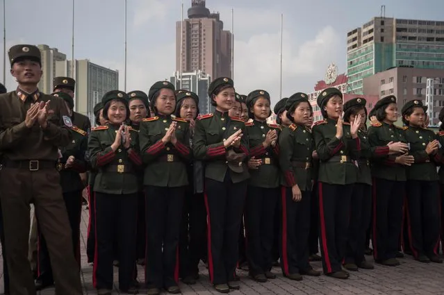 Korean People' s Army (KPA) soldiers applaud as they watch a screen showing news coverage of an August 29 missile test launch, in a public square outside a train station in Pyongyang on August 30, 2017. North Korea leader Kim Jong- Un has promised more missile flights over Japan, insisting his nuclear- armed nation' s provocative launch was a mere “curtain- raiser”, in the face of UN condemnation and US warnings of severe repercussions. (Photo by Kim Won- Jin/AFP Photo)