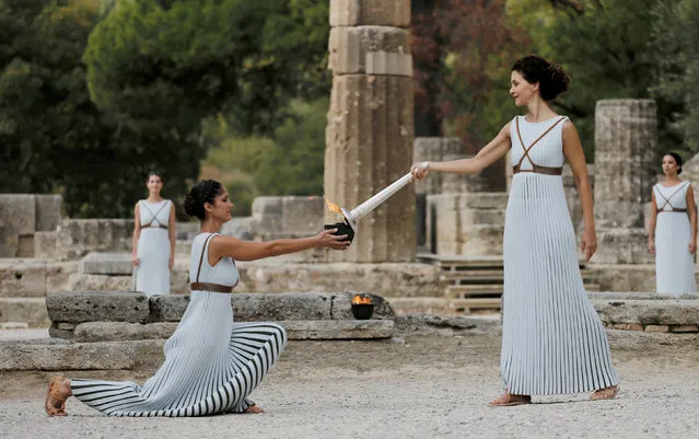 Greek actress Katerina Lehou, playing the role of High Priestess as she holds a torch during the dress rehearsal for the Olympic flame lighting ceremony for the Pyeongchang 2018 Winter Olympic Games at the site of ancient Olympia, Greece, October 23, 2017. (Photo by Alkis Konstantinidis/Reuters)