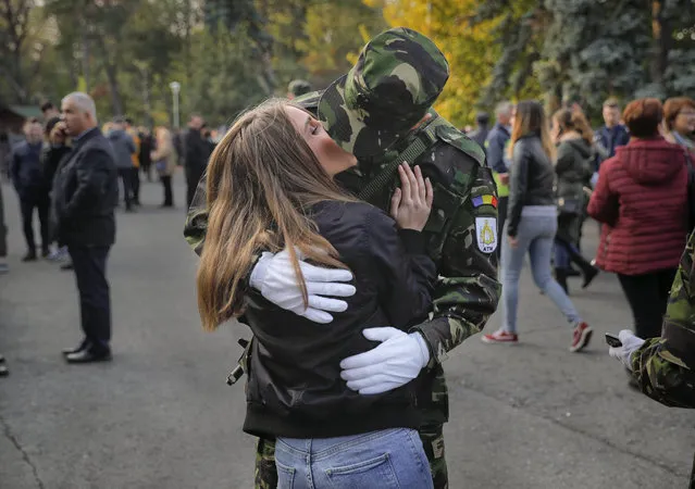 A couple kiss after the swearing in ceremony for the military students in Bucharest, Romania, Wednesday, October 25, 2017. (Photo by Vadim Ghirda/AP Photo)