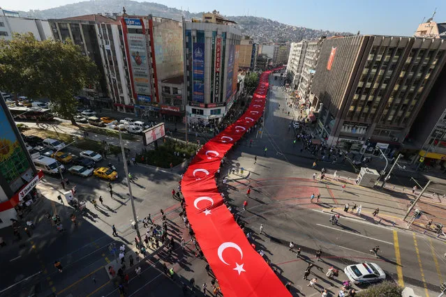 People carry 350 meters long giant Turkish flag during the Victory Parade within the 100th Independence day of Izmir, on September 09, 2022 in Izmir, Turkiye. (Photo by Mehmet Emin Menguarslan/Anadolu Agency via Getty Images)