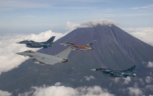 This handout photo taken and released by Japan's Ministry of Defense on September 28, 2022 shows Japanese F-2 fighter jets flying with German Air Force Eurofighters past Mount Fuji during German-Japan joint military drills aimed at strengthening defense cooperation between the two nations. (Photo by Handout/Japan's Ministry of Defense via AFP Photo)
