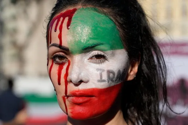 A woman is painted on a her face during a protest against the death of Mahsa Amini, a woman who died while in police custody in Iran, during a rally in central Rome, Saturday, October 29, 2022. Amini, a 22-year-old woman was held by Iran's morality police this month for allegedly wearing the mandatory Islamic headscarf too loosely. (Photo by Gregorio Borgia/AP Photo)