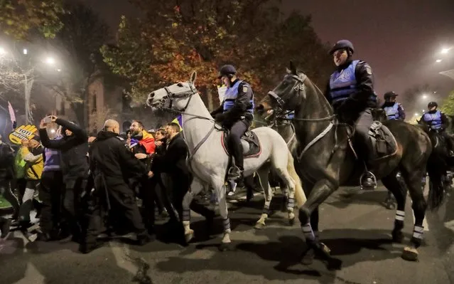 Mounted riot policemen control their horses during brief scuffles with protesters in Bucharest, Romania, Sunday, November 26, 2017. Thousands have protested in Romania's capital and other major cities against planned changes to the justice system they say will allow high-level corruption to go unpunished and a tax overhaul that could lead to lower wages. (Photo by Vadim Ghirda/AP Photo)