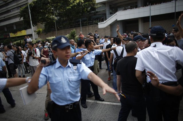 Police officers shout at protesters at the main protest site in Admiralty in Hong Kong October 13, 2014. (Photo by Carlos Barria/Reuters)