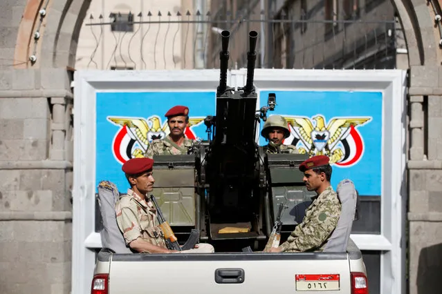 Soldiers ride on the back of a military truck stationed at the gate of Yemen's parliament during a session held by the parliament for the first time since a civil war began almost two years ago, in Sanaa, Yemen August 13, 2016. (Photo by Khaled Abdullah/Reuters)