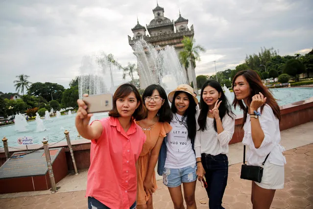 A group of women take a selfie in front Patuxay park in Vientiane, Laos September 5, 2016. (Photo by Soe Zeya Tun/Reuters)