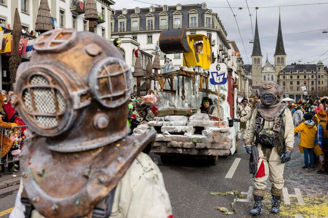 Carnival revellers parade through the streets during the carnival parade (Fritschi Umzug) on Fat Thursday, February 8, 2024 in Lucerne, Switzerland. The carnival in Lucerne takes place from February 8 through February 13. (Photo by Philipp Schmidli/Keystone)