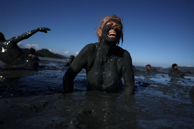 A woman covered in mud attends the “Bloco da Lama” (Block of Mud) group during the carnival festivities, in Paraty, Brazil February 10, 2024. (Photo by Pilar Olivares/Reuters)