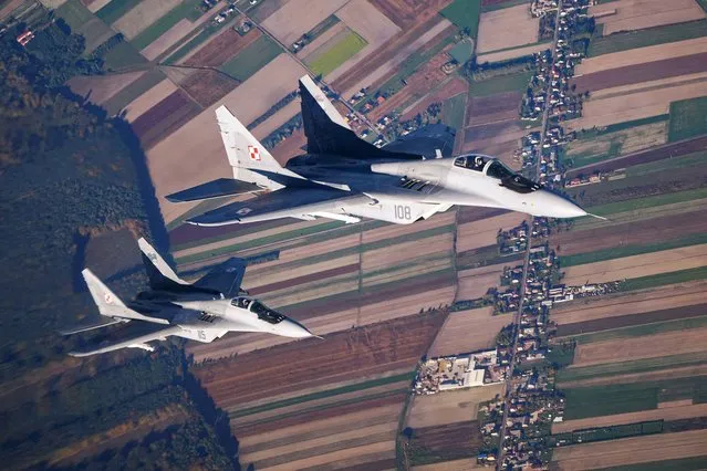 Two MiG 29 fighter jets take part in the NATO Air Shielding exercise near the air base in Lask, central Poland on October 12, 2022. (Photo by Radoslaw Jozwiak/AFP Photo)