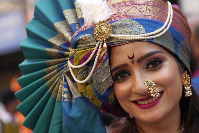 A woman dressed in traditional attire smiles during a procession marking Gudi Padwa or the Marathi New Year, in Mumbai, India, April 9, 2024. (Photo by Rajanish Kakade/AP Photo)