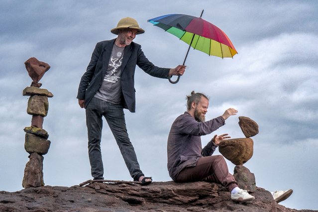 Artists James Craig Page (left) and Pontus Jansson practice balancing rocks on Bayswell Beach in Dunbar, ahead of the European Land Art Festival (ELAF) in East Lothian on Monday, July 14, 2025. The Festival is a week-long event and includes nature artists from all around the world creating sand drawings, wood sculptures and stone stacks using only materials found along the coast. (Photo by Jane Barlow/PA Images via Getty Images)