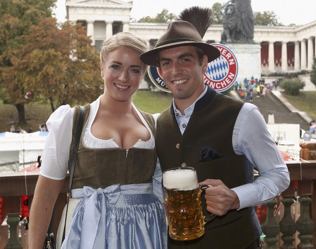 Philipp Lahm of FC Bayern Munich and his wife Claudia pose during their visit at the Oktoberfest in Munich, Germany, October 2, 2016. (Photo by Alexandra Beier/Reuters)