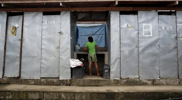 A teenage girl stands at a washroom of a transitional shelter for Typhoon Haiyan survivors in Tacloban city November 1, 2015, ahead of the second anniversary of the devastating typhoon that killed more than 6000 people in central Philippines. Thousands of families are still living on transitional shelters while awaiting for their permanent resettlement in central Philippines, local media reports said. Picture taken November 1, 2015. REUTERS/Erik De Castro
