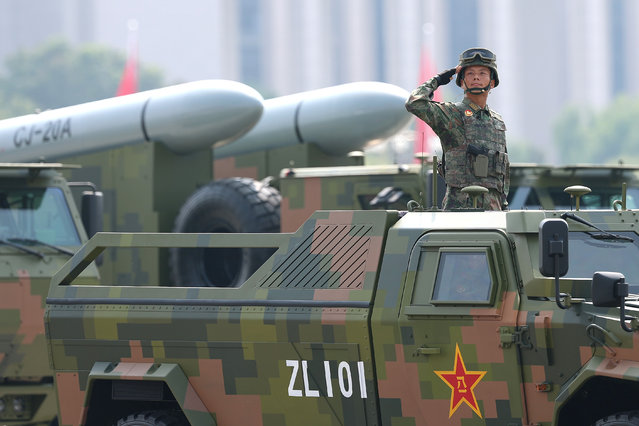 Armoured vehicles and soldiers are seen during a military parade marking the 80th anniversary of victory over Japan and the end of World War II, in Tiananmen Square on September 03, 2025, in Beijing, China. China's Victory Day military parade serves as a powerful display of national pride and military power. This year's parade carries heightened geopolitical weight with the attendance of leaders like Vladimir Putin, Kim Jong Un and Narendra Modi, underlining China's diplomatic alliances as it presents itself as an alternative global leader. (Photo by Lintao Zhang/Getty Images)