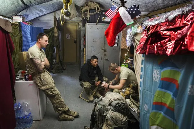 U.S. soldiers from the 3rd Cavalry Regiment relax in their quarters after taking part in a mortar exercise on forward operating base Gamberi in the Laghman province of Afghanistan December 24, 2014. (Photo by Lucas Jackson/Reuters)