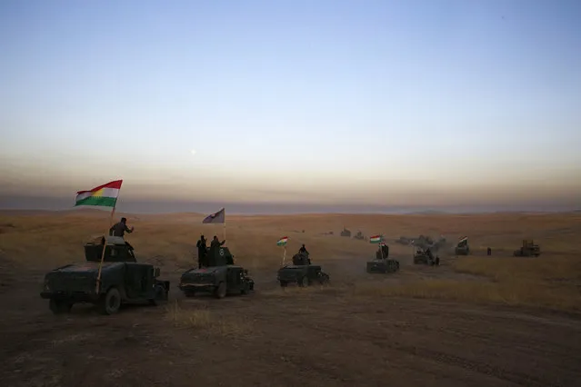A Peshmerga convoy drives towards a frontline in Khazer, about 30 kilometers (19 miles) east of Mosul, Iraq, Monday, October 17, 2016. The Iraqi military and the country's Kurdish forces say they launched operations to the south and east of militant-held Mosul early Monday morning. (Photo by Bram Janssen/AP Photo)