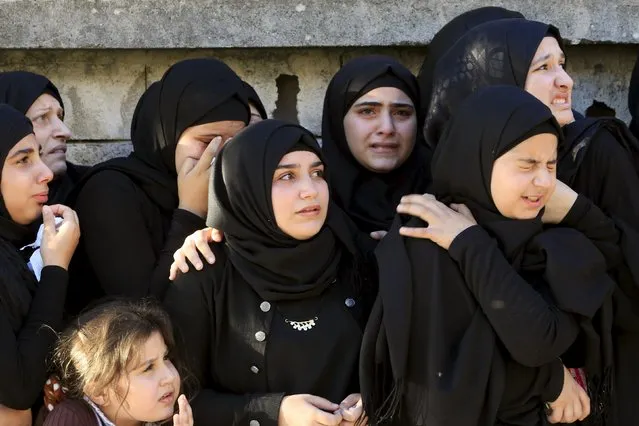 Muslim women and girls mourn during the funeral of Hezbollah member Ali Abbas Dia, who was killed in the two explosions that occurred on Thursday in Beirut's southern suburbs, during his funeral in Baflay village, southern Lebanon November 13, 2015. (Photo by Ali Hashisho/Reuters)