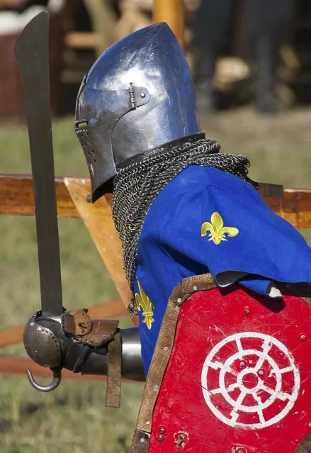 A French contestant runs during the “Battle of Nations” in Aigues-Mortes, southern France, Friday, May 10, 2013 where Middle Ages fans attend the historical medieval battle  competition. The championship will be attended by 22 national teams, which is twice the number it was last year. The battle lasts until May 12. (Photo by Philippe Farjon/AP Photo)