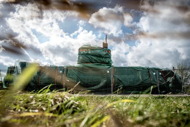 The submarine UC3 Nautilus is seen covered with green tarpaulin in Nordhavn, in Copenhagen, Denmark, April 25, 2018. Danish inventor Peter Madsen has been sentenced to life in prison for torturing and murdering Swedish journalist Kim Wall on his private submarine, it was also decided by the court that the submarine “UC3 Nautilus” must be confiscated. (Photo by Mads Claus Rasmussen/Reuters/Ritzau Scanpix)