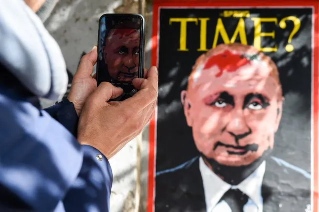 The new mural by street artist Harry Greb dedicated to the Ukrainian crisis. The poster, posted on the wall of the Lungotevere dei Tebaldi, depicts a hypothetical Time magazine cover that portrays the face of Russian President Valdimir Putin with a birthmark on his head in the shape of Ukraine (referring to the birthmark of Michail Gorbachev). Rome (Italy), February 17th, 2022. (Photo by Marilla Sicilia/Archivio Marilla Sicilia/Mondadori Portfolio via Getty Images)