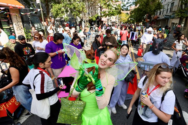 Owner Yochebed and her dog Ginger take part in the Annual Tompkins Square Halloween Dog Parade in New York City, U.S., October 19, 2025. (Photo by Kevin Coombs/Reuters)