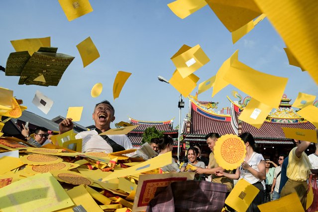  Chinese Indonesian Buddhists throw fake money to honour their ancestors during the Hungry Ghost Festival, held on the 15th day of the seventh lunar month and observed in Chinese communities with offerings of food, incense, and paper money to wandering spirits, at Gunung Timur Temple in Medan, North Sumatra, on September 6, 2025. (Photo by YT Hariono/AFP Photo)