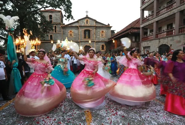 Filipino women in traditional costumes perform outside a Catholic church during a procession marking Easter Sunday, in Las Pinas City, Metro Manila, Philippines on April 9, 2023. Catholic faithful participated traditional events of Easter Sunday which depicts the biblical account of the reunion of Mother Mary and Jesus Christ who has risen from death. (Photo by Francis R Malasig/EPA/EFE)