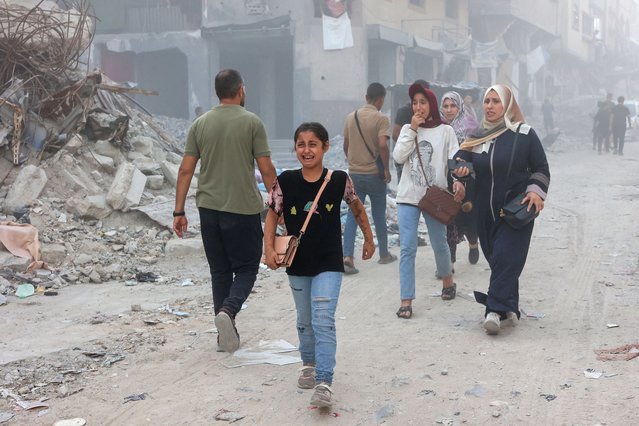 A Palestinian girl cries following Israeli bombardment which hit a school complex, including the Hamama and al-Huda schools, in the Sheikh Radwan neighbourhood in the north of Gaza City on August 3, 2024, amid the ongoing conflict between Israel and the militant Hamas group. (Photo by Omar Al-Qattaa/AFP Photo)