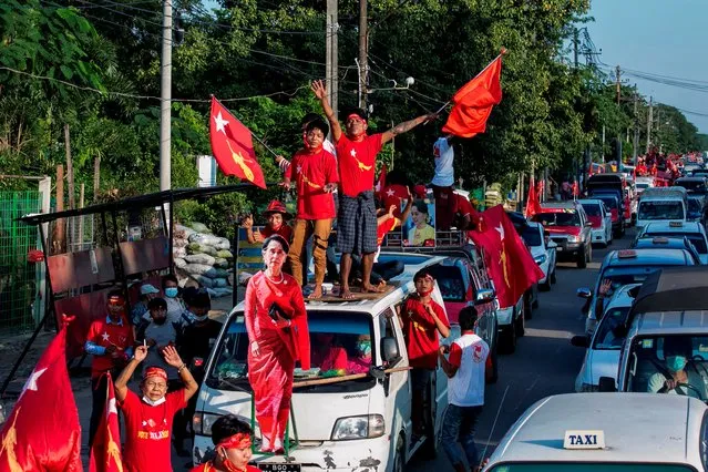 Supporters of the National League for Democracy (NLD) party celebrate with a cut-out figure of Myanmar state counsellor Aung San Suu Kyi in Yangon on November 10, 2020, as NLD officials said they were confident of a landslide victory in the weekend's election. (Photo by Sai Aung Main/AFP Photo)