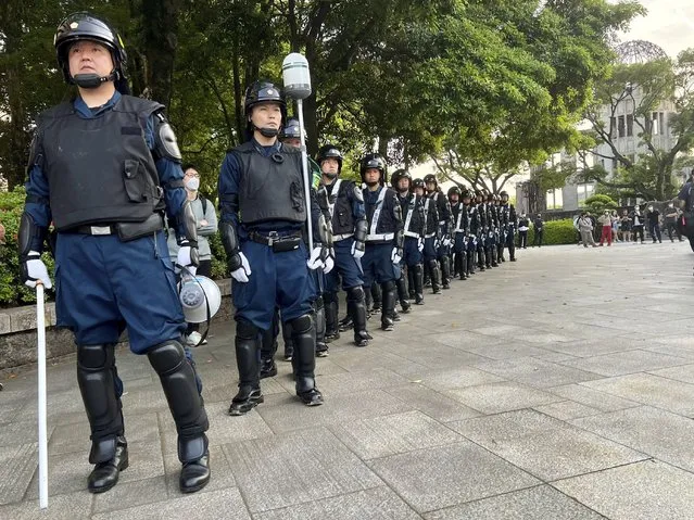 Police keep watch over a protest against the G-7 that is being held next to the Atomic Bomb Dome war memorial ahead of the group's meeting in Hiroshima, Japan, on Wednesday, May 17, 2023. The G-7 summit starts Friday. (Photo by Adam Schreck/AP Photo)