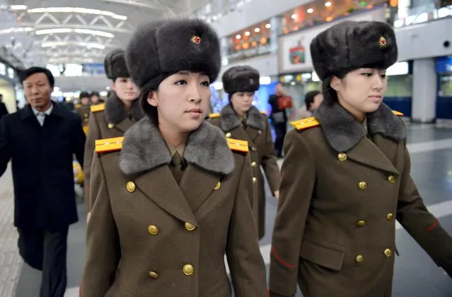 Members of the Moranbong Band of North Korea arrive at Beijing International Airport before departing from Beijing, China in this photo taken by Kyodo December 12, 2015. Members of an all-female North Korean pop music band left Beijing abruptly on Saturday before they were due to perform at a concert, heading back to Pyongyang, Japan's Kyodo news service reported. The band, formed by North Korean leader Kim Jong Un, was visiting China along with the North's State Merited Chorus and was due to perform later on Saturday at Beijing's National Center for the Performing Arts, Kyodo reported. (Photo by Reuters/Kyodo News)