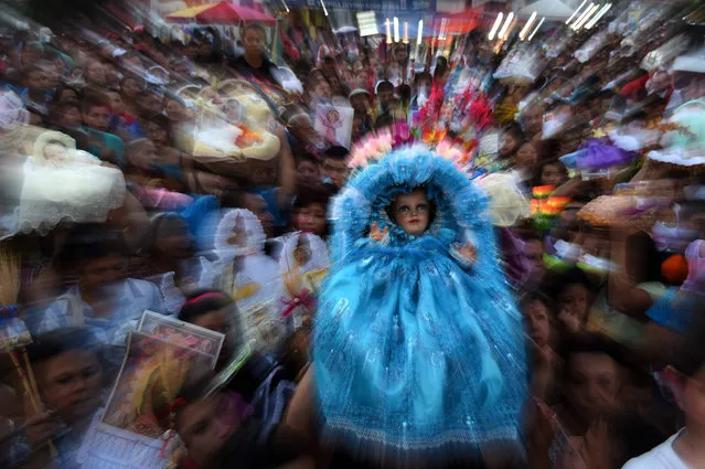 Catholic faithful carry Child Jesus Christ images during a procession for Holy Innocents Day in the town of Antiguo Cuscatlan, a suburb of San Salvador, on December 28, 2015. (Photo by Marvin Recinos/AFP Photo)